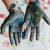 Childs hand covered in paint
